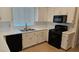 Well-lit kitchen featuring white cabinets, black appliances, and stainless steel sink at 10337 Adams Chase St, Las Vegas, NV 89183