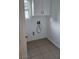 Practical laundry room with tiled floor, storage cabinet and utility connections at 10337 Adams Chase St, Las Vegas, NV 89183