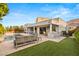 Relaxing backyard featuring a modern pool, covered patio, outdoor seating, and beautiful mountain views at 10482 Calico Terrace Ave, Las Vegas, NV 89135