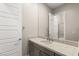 Neutral bathroom with a large mirror, modern vanity, and white trim at 10482 Calico Terrace Ave, Las Vegas, NV 89135