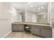 Bathroom with double vanity, cabinets, and a large mirror at 10482 Calico Terrace Ave, Las Vegas, NV 89135