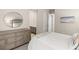 Bright bedroom with dresser, white bedding and neutral decor at 10482 Calico Terrace Ave, Las Vegas, NV 89135