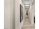 Hallway with sleek wood flooring, white trim, and stylish artwork at 10482 Calico Terrace Ave, Las Vegas, NV 89135