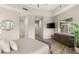 The main bedroom has wood floors, a TV, and access to the bathroom at 10482 Calico Terrace Ave, Las Vegas, NV 89135