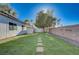 A large backyard with a large lawn and pavers at 10518 Santerno St, Las Vegas, NV 89141