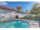 Home exterior overlooking a pool and lawn area at 10518 Santerno St, Las Vegas, NV 89141