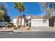 Charming single-story home featuring desert landscaping, a tile roof, and an attached two-car garage at 10518 Santerno St, Las Vegas, NV 89141