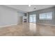 Bright living room with tile flooring, fireplace, and sliding glass door leading to the backyard at 10518 Santerno St, Las Vegas, NV 89141