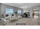 A staged living room and dining room area with a neutral color palette and tile flooring at 10518 Santerno St, Las Vegas, NV 89141