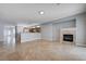 Open living room featuring tile floors and a cozy fireplace at 10518 Santerno St, Las Vegas, NV 89141