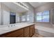 Bright bathroom with dual sinks, soaking tub, and natural light at 10518 Santerno St, Las Vegas, NV 89141