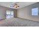 Spacious bedroom featuring ample carpeted area and sliding glass doors at 10518 Santerno St, Las Vegas, NV 89141