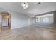 Expansive living area with tile flooring, arches, and neutral tones offers a versatile living space at 10518 Santerno St, Las Vegas, NV 89141