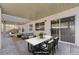 Covered patio featuring stone flooring, a dining table, and comfortable seating at 10518 Santerno St, Las Vegas, NV 89141