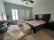 Bedroom with a ceiling fan and natural light streaming through shuttered windows at 119 Colantonio Ct, Las Vegas, NV 89138