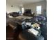 Spacious living room featuring dark wood floors, large windows, and comfortable seating arrangement at 119 Colantonio Ct, Las Vegas, NV 89138