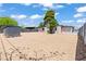 Spacious backyard featuring a gravel area, mature trees, shed, and secure fencing, perfect for outdoor enjoyment at 1417 Dogwood Ave, North Las Vegas, NV 89030