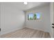 Well-lit bedroom with wood-look floors, a flush mount ceiling light, and a window at 1417 Dogwood Ave, North Las Vegas, NV 89030