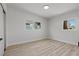 Bright bedroom with white brick walls, wood-look floors, and a large window at 1417 Dogwood Ave, North Las Vegas, NV 89030