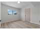 Clean bedroom with wood-look floors, a window, and a flush mount ceiling light at 1417 Dogwood Ave, North Las Vegas, NV 89030
