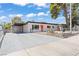 Charming single-story home featuring a carport, xeriscaping, and a vibrant red front door at 1417 Dogwood Ave, North Las Vegas, NV 89030