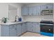 Modern kitchen boasts blue cabinets, stainless steel appliances, and quartz countertops at 1417 Dogwood Ave, North Las Vegas, NV 89030