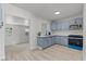 Stylish kitchen featuring blue cabinetry, stainless steel appliances, and laminate flooring at 1417 Dogwood Ave, North Las Vegas, NV 89030