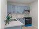 Well-lit kitchen featuring blue cabinets, quartz countertops, and modern appliances at 1417 Dogwood Ave, North Las Vegas, NV 89030