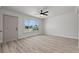 Bright living room with laminate floors, white brick walls, and an abundance of natural light at 1417 Dogwood Ave, North Las Vegas, NV 89030