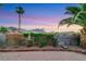 Fully fenced backyard with gravel, palm trees, and mountain views at 160 Coastal Pier Ct, Henderson, NV 89002