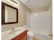Bathroom with cherry cabinets, single sink vanity, and shower-tub combo at 160 Coastal Pier Ct, Henderson, NV 89002