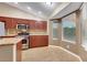 Well-lit kitchen with stainless steel appliances, granite countertops, and tile flooring at 160 Coastal Pier Ct, Henderson, NV 89002