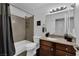 Bathroom with granite countertop vanity, framed mirror, shower-tub combination and modern fixtures at 2451 N Rainbow Blvd # 2043, Las Vegas, NV 89108