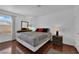 Bright bedroom featuring wood floors, a modern dresser, and a large window overlooking the outside at 2451 N Rainbow Blvd # 2043, Las Vegas, NV 89108