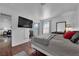 Bedroom featuring wood floors, a modern dresser, a mounted tv and a window with outdoor view at 2451 N Rainbow Blvd # 2043, Las Vegas, NV 89108