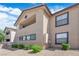 Neutral stucco condominium building featuring dark trim windows and spacious balcony at 2451 N Rainbow Blvd # 2043, Las Vegas, NV 89108