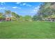 Expansive and well-manicured green space with mature trees and nearby buildings at 2451 N Rainbow Blvd # 2043, Las Vegas, NV 89108