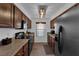 Contemporary kitchen with wood cabinets, granite countertops, stainless steel appliances, and modern lighting at 2451 N Rainbow Blvd # 2043, Las Vegas, NV 89108