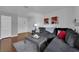 Comfortable living room features a plush grey sofa, hardwood floors and a minimalist decor at 2451 N Rainbow Blvd # 2043, Las Vegas, NV 89108