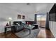 Comfortable living room features a plush grey sofa, hardwood floors and a minimalist decor at 2451 N Rainbow Blvd # 2043, Las Vegas, NV 89108