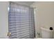 Bathroom featuring a gray and white striped shower curtain and neutral walls at 3322 Dragon Fly St, North Las Vegas, NV 89032