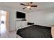 Spacious bedroom featuring a ceiling fan, light wood floors, and a television mounted above a dresser at 3322 Dragon Fly St, North Las Vegas, NV 89032
