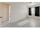 Bedroom with light wood floors, black out curtains and a view into the hallway at 3322 Dragon Fly St, North Las Vegas, NV 89032