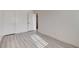 Bright bedroom featuring wood-look flooring, white walls, and closet, great for a minimalist design at 3322 Dragon Fly St, North Las Vegas, NV 89032