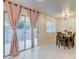 Bright dining room with sliding glass doors, a wood table, and seating for six at 3322 Dragon Fly St, North Las Vegas, NV 89032