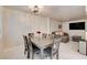 Open dining area with a wood table, seating for six, and views into a comfortable living area at 3322 Dragon Fly St, North Las Vegas, NV 89032
