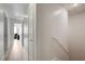 Bright hallway featuring modern wood flooring and neutral-toned walls leads to various rooms within the home at 3322 Dragon Fly St, North Las Vegas, NV 89032