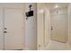 Hallway with white doors, tiled floor, and wall decorations creating a clean, welcoming entrance at 3322 Dragon Fly St, North Las Vegas, NV 89032