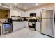 Well-equipped kitchen with sleek white cabinetry, stainless steel appliances, and a built-in beverage cooler at 3322 Dragon Fly St, North Las Vegas, NV 89032