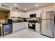 Updated kitchen with white cabinets and stainless steel appliances at 3322 Dragon Fly St, North Las Vegas, NV 89032